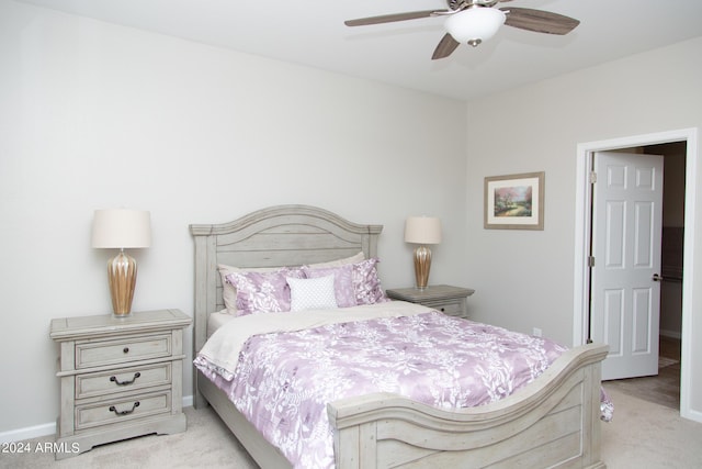 carpeted bedroom with baseboards and a ceiling fan