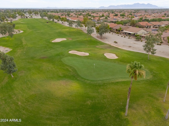 drone / aerial view featuring a mountain view, view of golf course, and a residential view