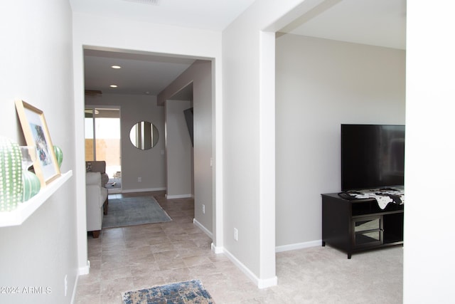 hallway featuring visible vents and baseboards