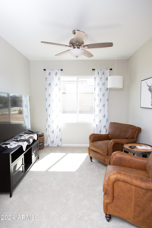 living room with ceiling fan and carpet flooring