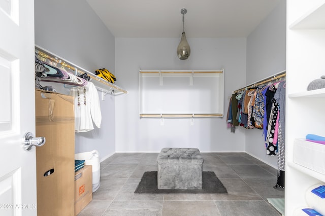 spacious closet with tile patterned floors