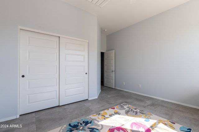 unfurnished bedroom with tile patterned flooring and a closet