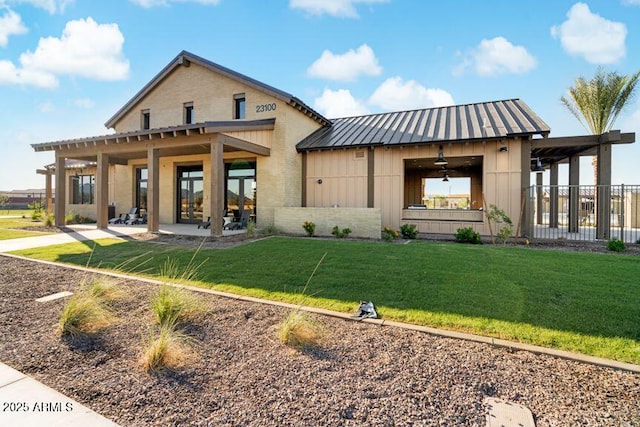22553 S 204th Ct, Queen Creek, AZ 85142 - rear view of house with a lawn, board and batten siding, brick siding, french doors, and a patio