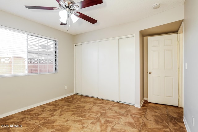 2227 N 57th Dr, Phoenix, AZ 85035 - unfurnished bedroom with a closet, baseboards, and a ceiling fan