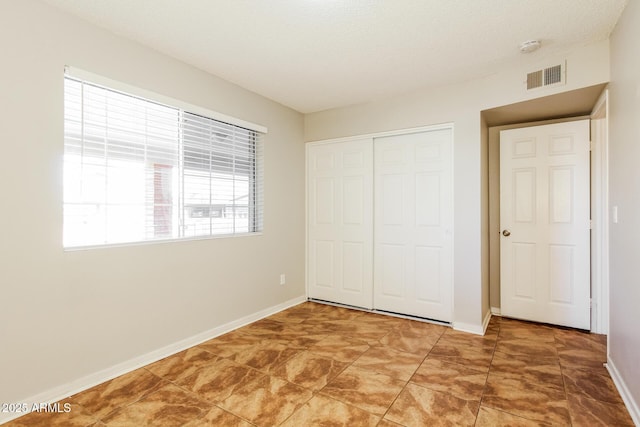 2227 N 57th Dr, Phoenix, AZ 85035 - unfurnished bedroom featuring a closet and baseboards