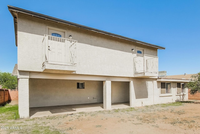 2227 N 57th Dr, Phoenix, AZ 85035 - rear view of property with a balcony, stucco siding, and a patio