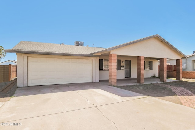 2227 N 57th Dr, Phoenix, AZ 85035 - ranch-style home featuring cooling unit, a porch, driveway, and an attached garage