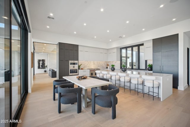 dining space with light hardwood / wood-style flooring