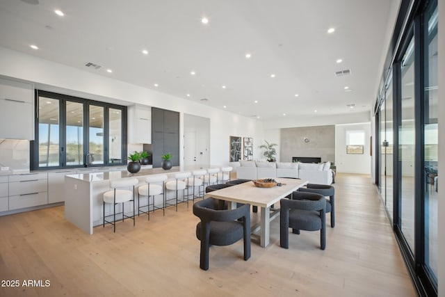 dining room featuring sink and light wood-type flooring