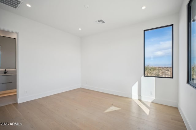 empty room with light hardwood / wood-style floors