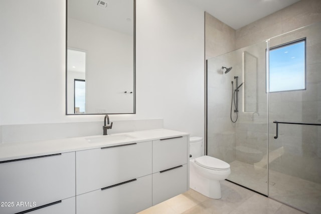 bathroom with walk in shower, vanity, and toilet