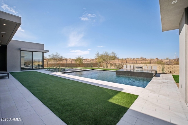 view of swimming pool featuring pool water feature and a patio