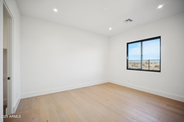 spare room featuring light hardwood / wood-style flooring