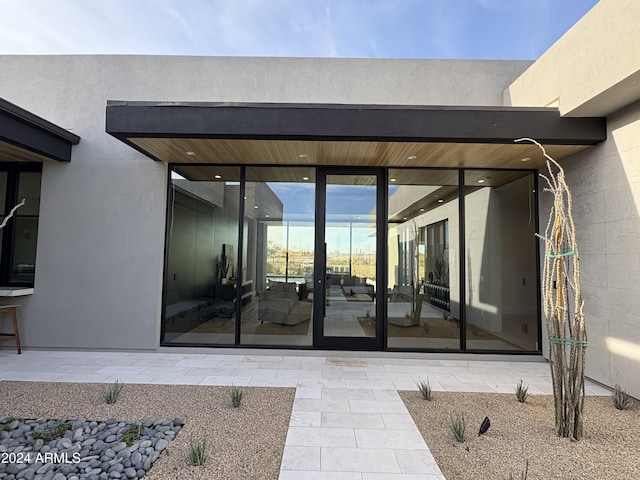 property entrance featuring a patio area