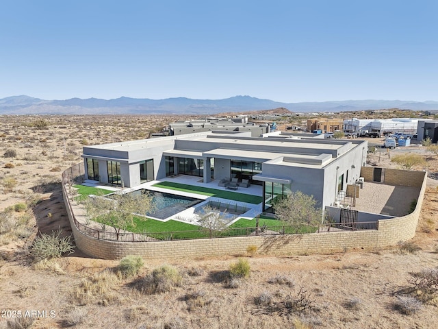 rear view of house featuring a mountain view and a patio area