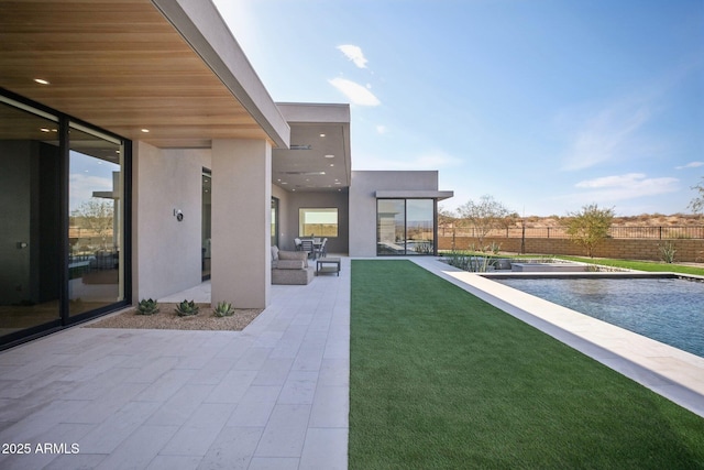 exterior space featuring a fenced in pool and a patio