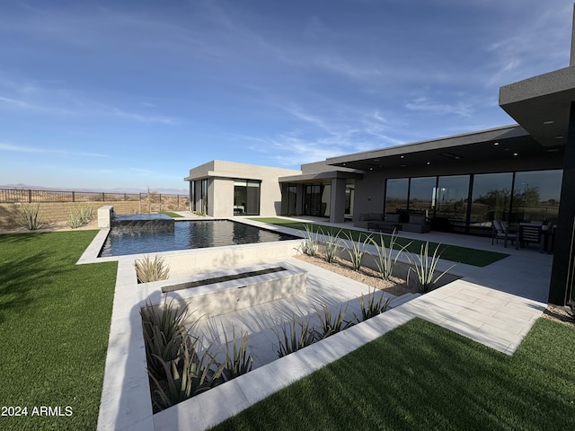 view of swimming pool featuring an outdoor hangout area, pool water feature, a patio area, and a lawn