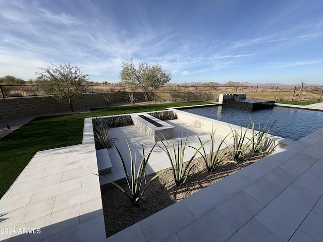 view of pool with a patio area and pool water feature