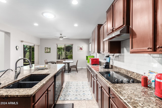 kitchen with sink, light tile patterned floors, ceiling fan, light stone countertops, and black appliances