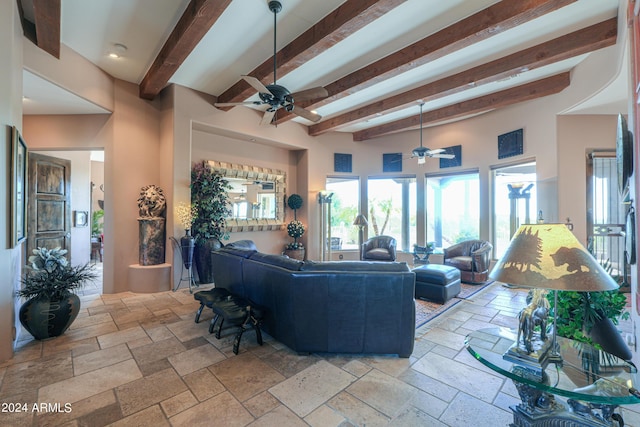 living room featuring beamed ceiling and ceiling fan