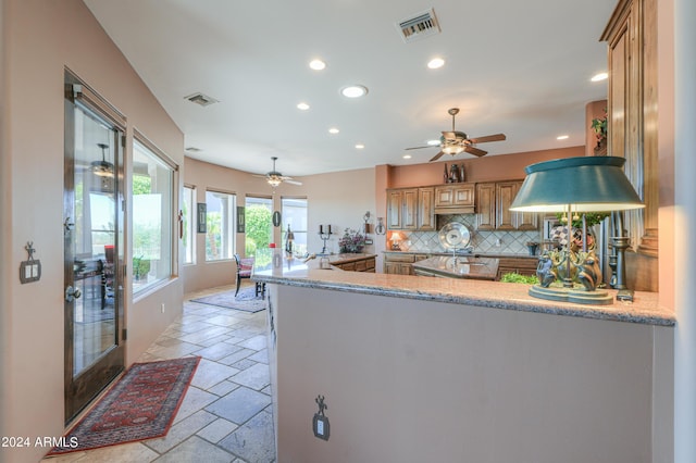 kitchen with decorative backsplash and kitchen peninsula