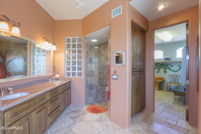 bathroom featuring vanity and a shower with shower door