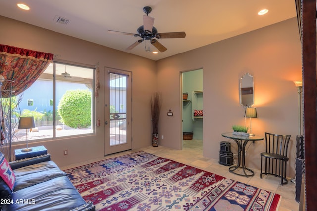 tiled living room with ceiling fan