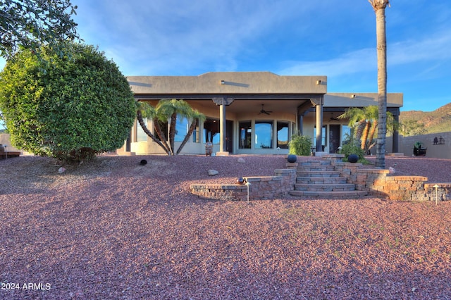 rear view of house featuring ceiling fan