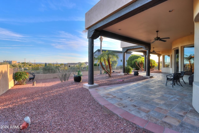 view of yard featuring ceiling fan and a patio