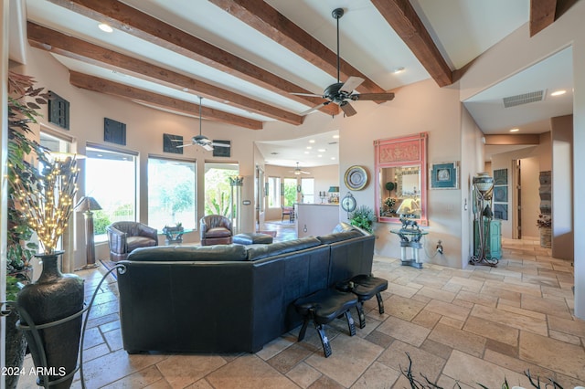 living room featuring beamed ceiling and ceiling fan