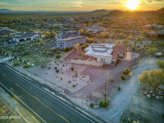 aerial view at dusk featuring a mountain view