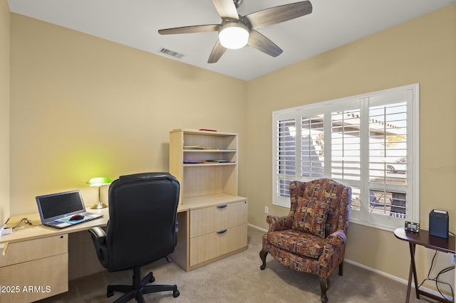 home office with light carpet and ceiling fan