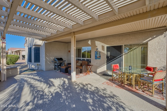 view of patio featuring a grill and a pergola