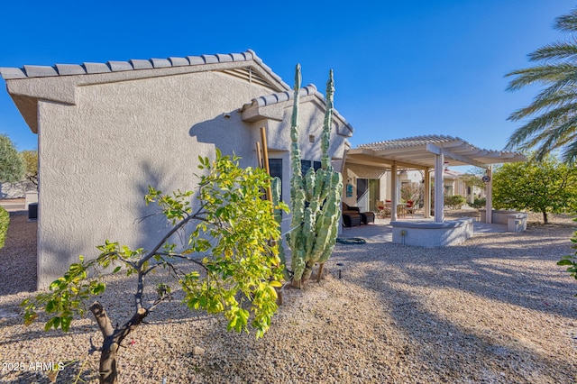 rear view of house with a pergola and a patio