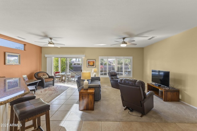 living room featuring light tile patterned flooring and ceiling fan