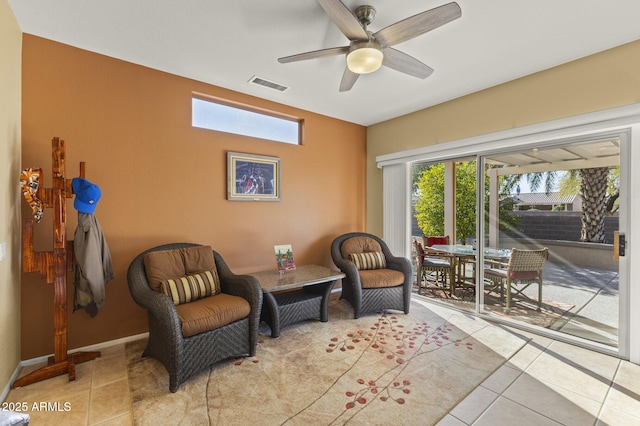 sitting room with light tile patterned floors and ceiling fan