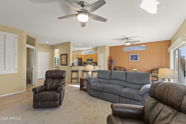 tiled living room featuring ceiling fan