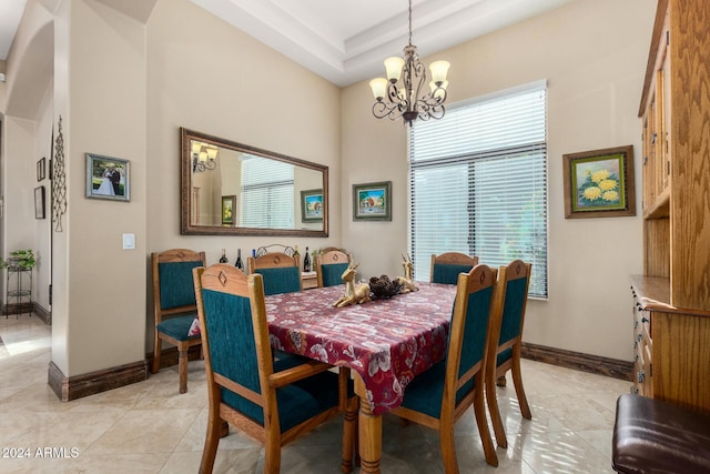 tiled dining space featuring a chandelier