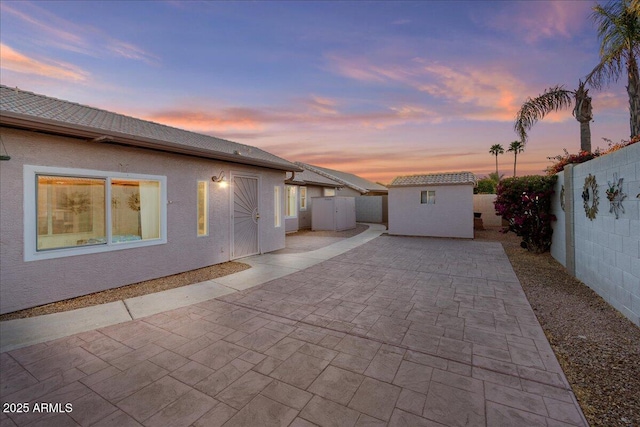 exterior space featuring a patio, a fenced backyard, and stucco siding