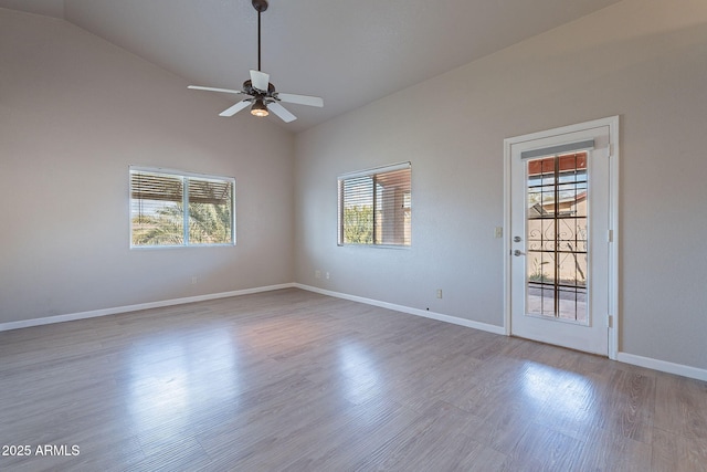 empty room featuring lofted ceiling, wood-type flooring, and ceiling fan