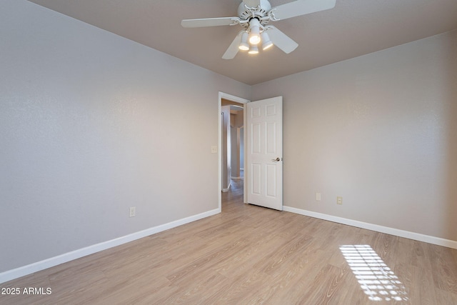 empty room featuring ceiling fan and light hardwood / wood-style flooring