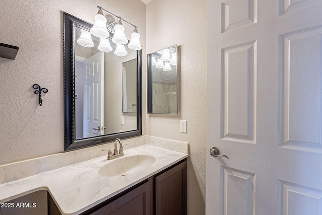 bathroom with an inviting chandelier and vanity