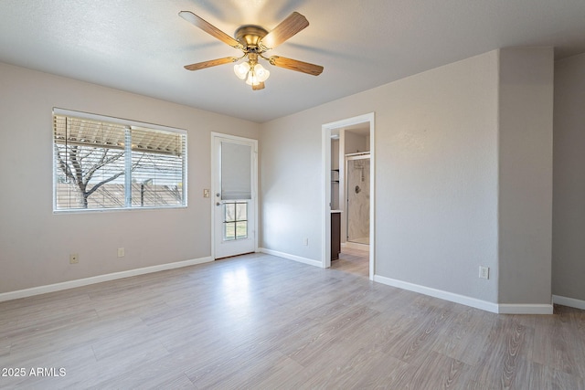 unfurnished room with ceiling fan and light wood-type flooring