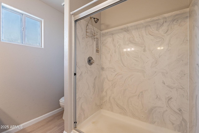 bathroom featuring an enclosed shower, hardwood / wood-style floors, and toilet