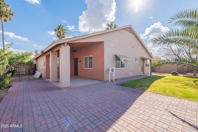 rear view of house featuring a patio and ceiling fan