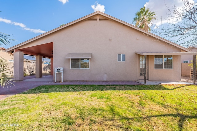 rear view of property with a patio and a lawn