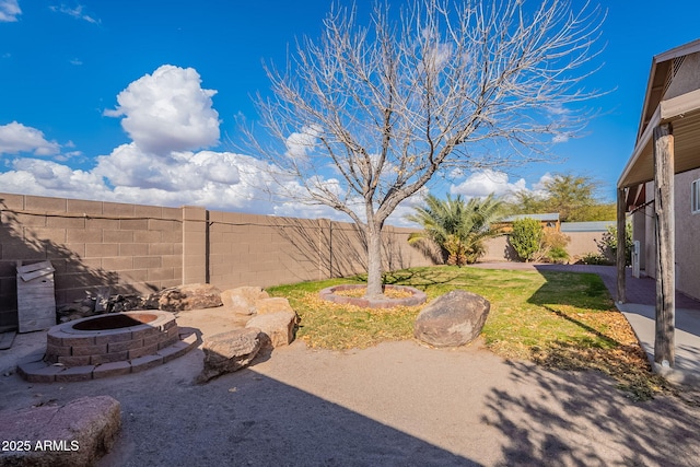 view of yard featuring a patio and an outdoor fire pit