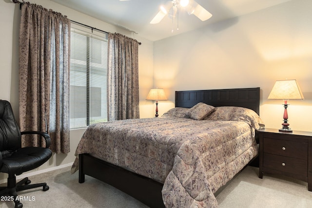 carpeted bedroom featuring ceiling fan and multiple windows