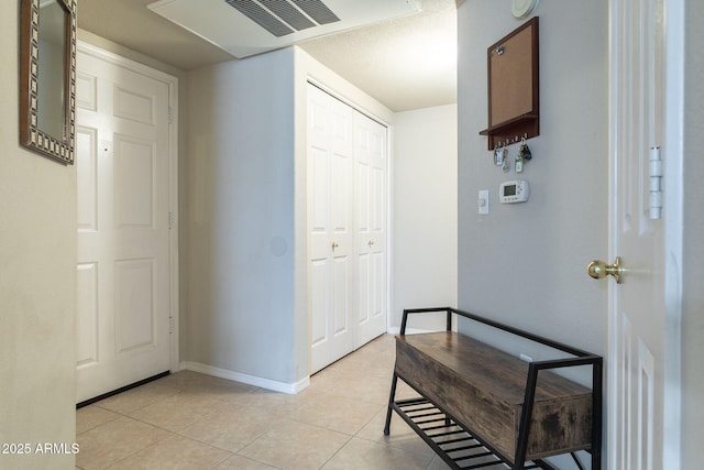 corridor with light tile patterned floors