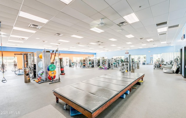 workout area with visible vents and a paneled ceiling